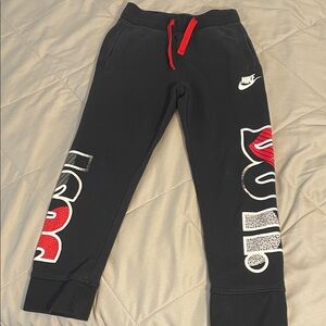 Nike Kids Black Joggers with Red and White Graphics